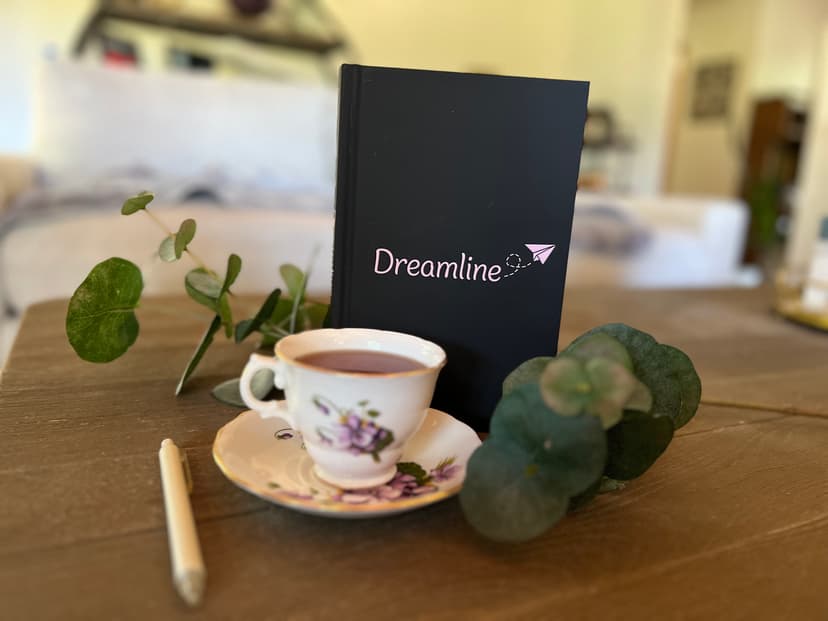 Dreamline Journal Preview - A cozy scene with journal, teacup, and eucalyptus leaves